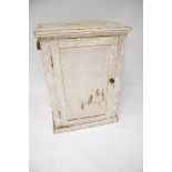 A vintage white painted pine cupboard. With a single door and two shelves, L66cm x D40.