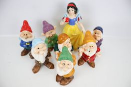A set of Snow White and the Seven Dwarves china figures. Stamped 'Disney', max.