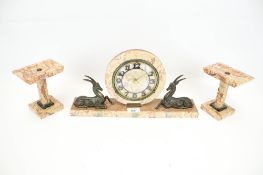 An Art Deco mantle clock garniture with antelope figures.