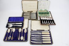 Six boxes of silver plated knives,