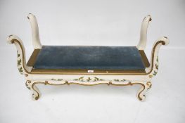 A painted and upholstered bench seat.