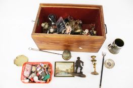 A wooden box with a slide top and a collection of miscellaneous objects.