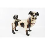 A life size ceramic model of a Pug dog.
