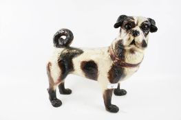 A life size ceramic model of a Pug dog.