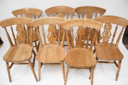 A set of seven pine kitchen chairs.
