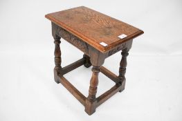 A dark oak jointed rectangular stool.