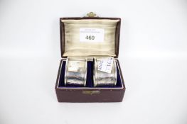 A boxed pair of silver napkins rings