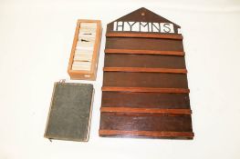A 20th century wooden hymn board, a set of number slides and a bible.