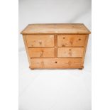 A vintage pine chest of drawers. Two short over two short and one long. On bun feet.