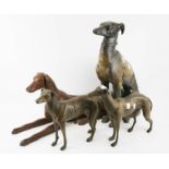 Four cast metal models of greyhounds.