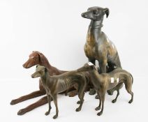 Four cast metal models of greyhounds.