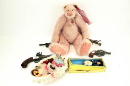 A collection of assorted toys. Including a 'Raspberry Sorbet' teddy bear, dolls, cap guns, etc.