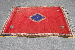 A Persian style wool rug.