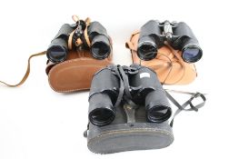 Three pairs of vintage binoculars cased. Including Prinz 10 x 50, Halina 10 x 50 and Zenith 16 x 50.