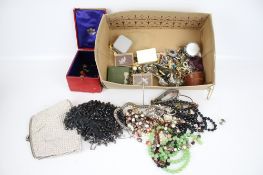 A collection of assorted costume jewellery. Including two evening bags, brooches, etc.