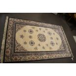 A Persian style wool cream and pattern rug,