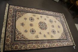 A Persian style wool cream and pattern rug,