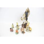 A collection of eight assorted china bird figurines. Including seven Royal Worcester plus an eagle.