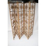 A 20th century five panel bamboo screen. Decorated with swirls and overlaid details.