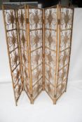 A 20th century five panel bamboo screen. Decorated with swirls and overlaid details.