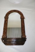 An arch top wooden framed wall mirror.