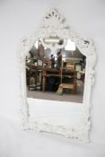 A contemporary white painted framed wall mirror.