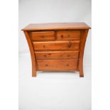 A contemporary chest of stained pine drawers.