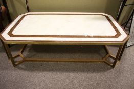 A contemporary brass framed marble top coffee table.