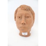 A 20th century terracotta studio pottery head of a woman. With cropped hair, H21.