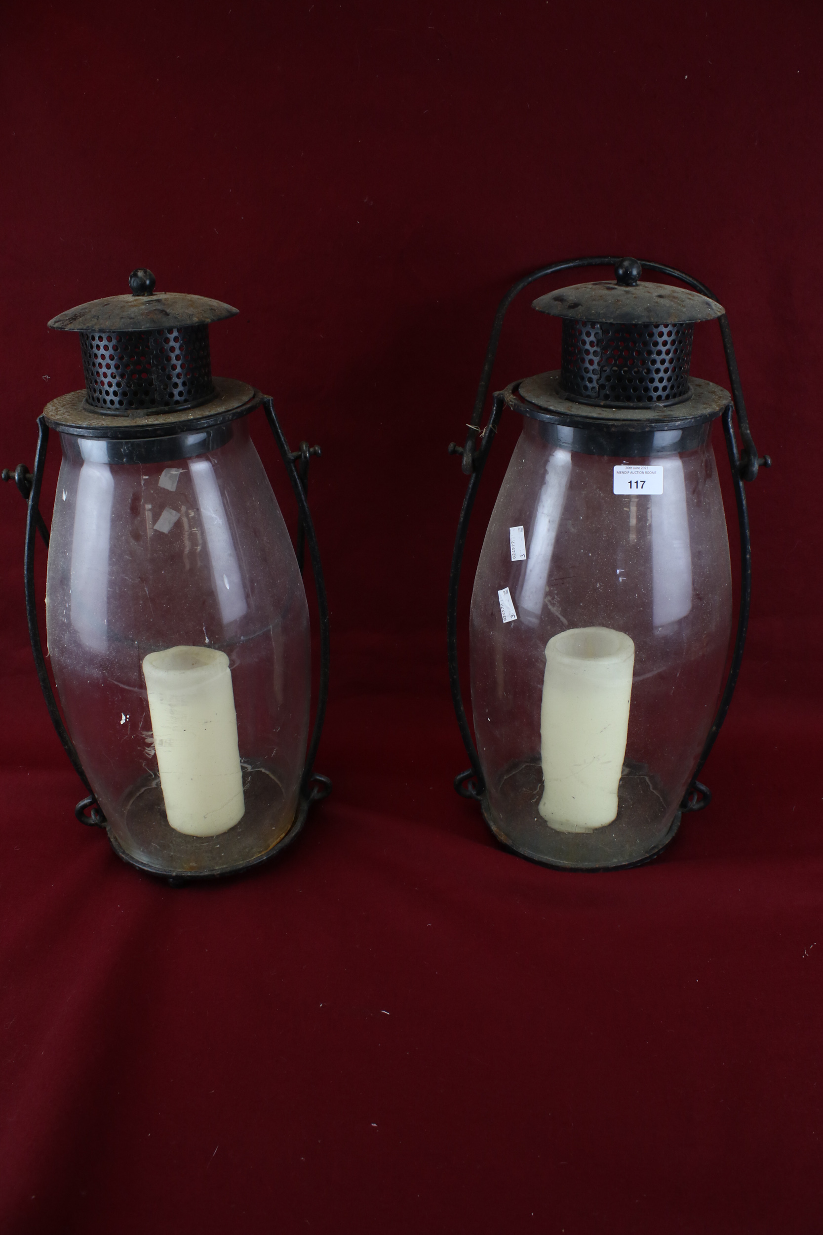 A pair of large garden metal and glass lamps.