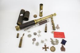 A collection of assorted vintage militaria. Including badges and medals, etc.