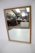 A large framed wall mirror.