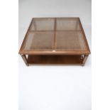 A contemporary square cane top coffee table.