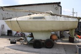 A vintage 6m day cruiser sailing boat and trailer.