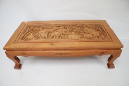 A Far Eastern hardwood heavily carved coffee table.