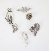 Six silver and white metal brooches in the form of cats, thistles, flower, etc.