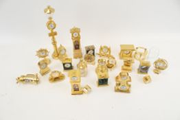 A collection of 22 assorted brass cased miniature novelty clocks/timepieces.