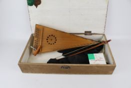 A triangular 24 stringed musical instrument and bow.