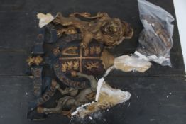 A plaster coat of arms on a wooden shield.