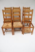 Six wooden chairs with wicker seats (one AF)