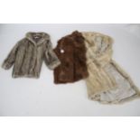 Three variously coloured women's fur coats. Including a full length mink labelled 'M.