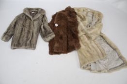 Three variously coloured women's fur coats. Including a full length mink labelled 'M.