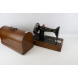 A vintage oak cased Singer sewing machine No 99 hand crank.