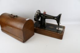 A vintage oak cased Singer sewing machine No 99 hand crank.