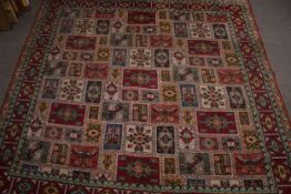 A large square patterned wool carpet rug.