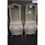 A pair of contemporary Rococo style painted and glazed cabinets.