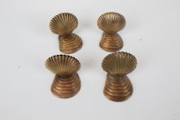 Four place name holders in shell form. Pressed copper cockle shell shape on a ridged base, H3.