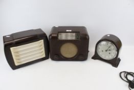 A Bakelite valve radio, speaker, and a clock. Including a Bush Type DAC 90A, s/n.