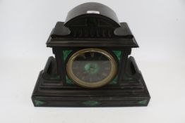 A Victorian black slate and green malachite mantle clock.