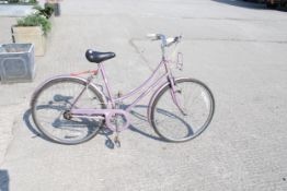 A women's vintage Raleigh Caprice bicycle.